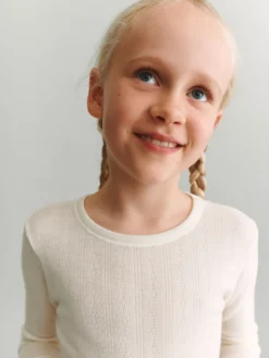 Bluse med hulmønster i merinould til børn