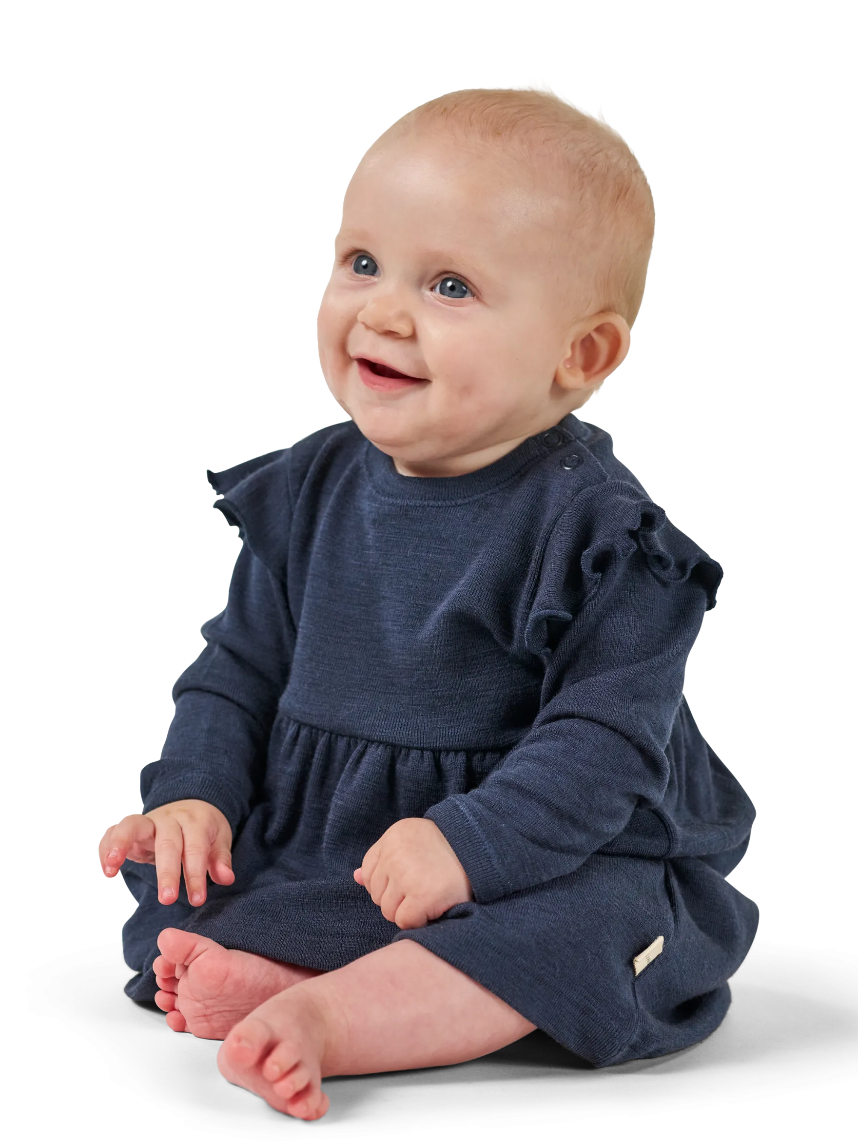 Kjole med flæser i merinould til baby